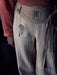 Light-colored pants with black patterns on a dark background