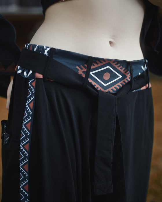 Black garment with patterned waistband and hem