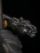 Close-up of a metallic object with a detailed design on a dark background