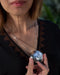 Person holding a silver sequin ball with a blurred background