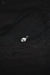 Silver pendant on a dark textured fabric background