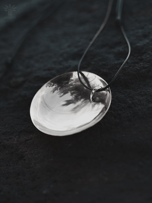 Silver pendant necklace on a dark textured background
