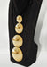 Black boot with gold spherical decorations on a white background
