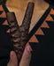 Wooden y-shaped tool held by a hand against a patterned background