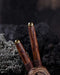 A hand presents a wooden kuripe pipe, meticulously handcrafted for hape snuff application This unique smoking accessory, with its necklace design and rustic charm, exemplifies traditional shamanic tools and doubles as a protective herbal medicine kit