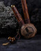 A hand presents a wooden kuripe pipe, meticulously handcrafted for hape snuff application This unique smoking accessory, with its necklace design and rustic charm, exemplifies traditional shamanic tools and doubles as a protective herbal medicine kit
