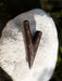 Brown shell-like object on a textured white surface