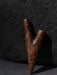 Wooden archery bow nock on a dark background