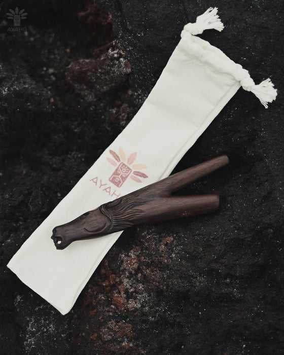 Wooden tool on a white drawstring bag with 'AYAH' branding on a dark textured background