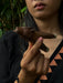 Person holding a chocolate bar with a dark background