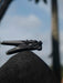 Black decorative object on a rock with a blurred natural background