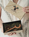Matching crescent moon and star hairpins, one in teak and one in rosewood, styled in twin braids