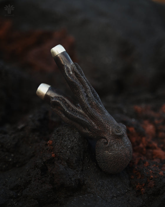 Kuripe made from rosewood, featuring octopus carvings that showcase the natural wood texture.