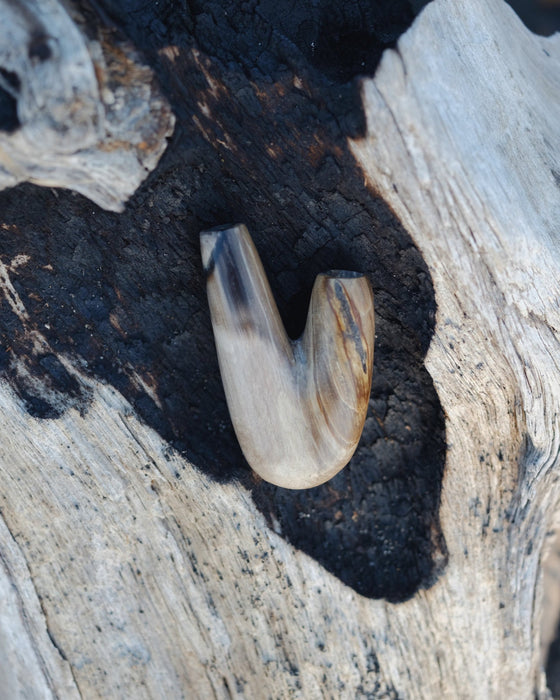 Warm hues of the Kuripe pipe made from petrified wood, inviting and comforting.