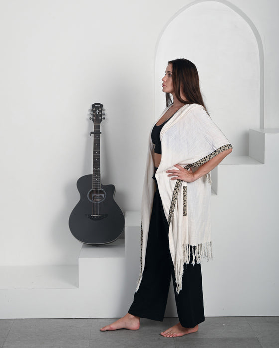 Lightweight yet warm shaman-style poncho featuring hand-woven details and earthy boho aesthetics, ideal for layering in any bohemian wardrobe."Lightweight yet warm shaman-style poncho featuring hand-woven details and earthy boho aesthetics, ideal for layering in any bohemian wardrobe."