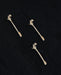 Three silver floral hair pins on a black background