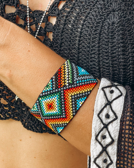 Handwoven bead loom bracelets with Ayahuasca-inspired tribal patterns, combining shamanic tools and talisman amulets for spiritual adornment