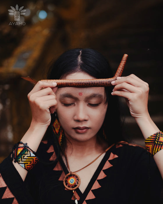 Person wearing traditional attire with a blurred background
