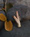 Teakwood kuripe alongside hape snuff, illustrating its use in traditional shamanic practices