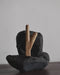 Teakwood kuripe displayed with sacred objects, symbolizing its role in spiritual ceremonies