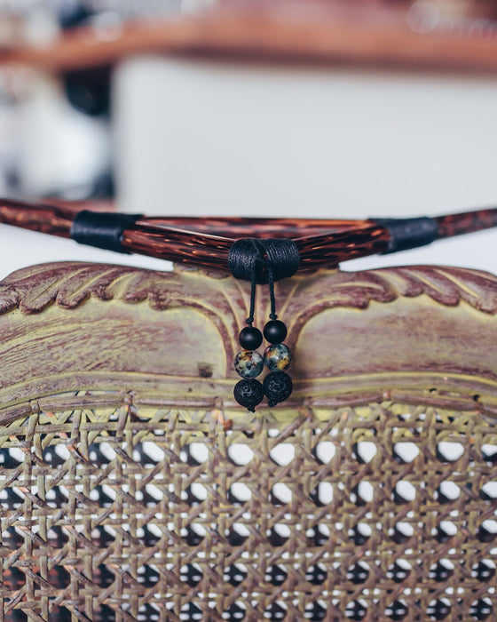 Necklace with black beads on a textured surface
