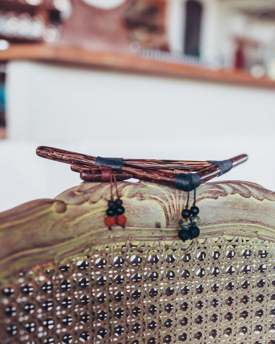Decorative hair stick with beads on a woven background