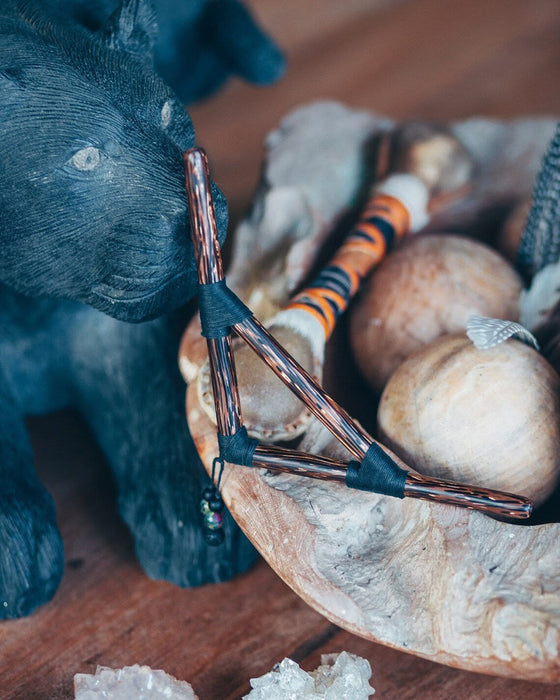 Close-up of a small bicycle model on a rock with a blue elephant toy in the foreground.
