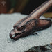 Wooden eagle head carving on a stone surface