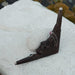 Decorative wall hook with face design on a textured surface