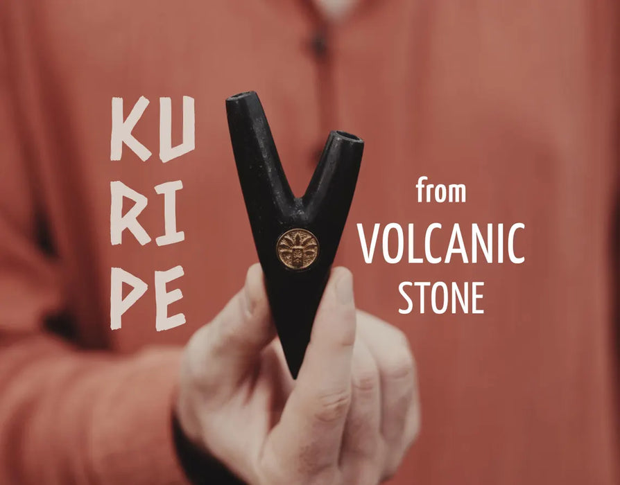 Hand holding a black tool with 'Kuripe' and 'from Volcanic Stone' text on a red background