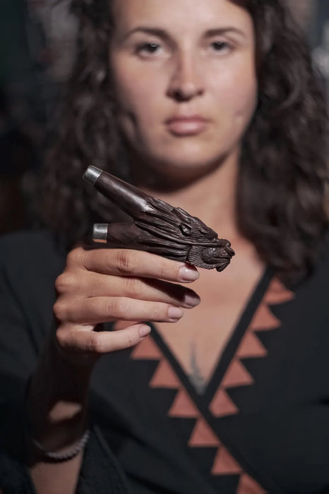 Person holding a decorative object with intricate design