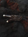 Decorative wooden object with intricate carvings on a dark textured background