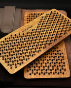 Two wooden brush scrubbers with textured surface on a dark background