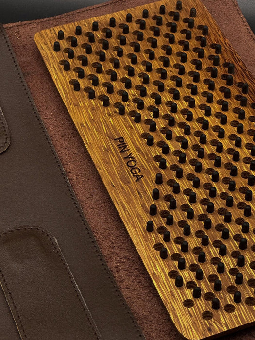 Wooden yoga mat with textured surface on a brown background