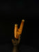 Wooden walking cane with a hand holding it against a black background