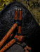 Wooden tools with black bands on a dark stone surface