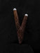 Two wooden pens with silver accents on a dark textured background