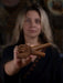 Person holding a wooden dragon figurine with a blurred background