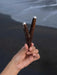 Hand holding a decorative object against a dark water background
