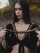 Woman holding a wooden object with a blurred natural background
