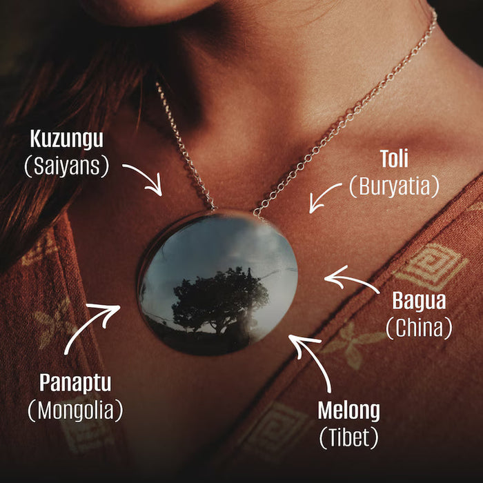 Necklace with a round pendant featuring a tree reflection, labeled with geographical names.