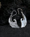 Exquisite Angel Wings earrings, crafted from lustrous mother-of-pearl and detailed sterling silver, radiating aesthetic grace and ethereal charm