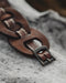 Durable buffalo hide bracelet with intertwined infinity symbols, a handcrafted statement piece for strength and balance.