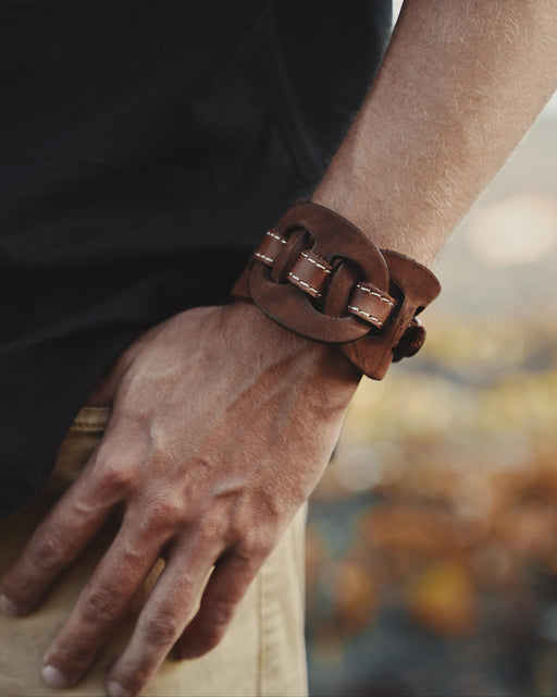 Handcrafted men’s leather cuff with triple-infinity design, symbolizing everlasting flow and cyclical energy.