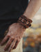 Handcrafted men’s leather cuff with triple-infinity design, symbolizing everlasting flow and cyclical energy.