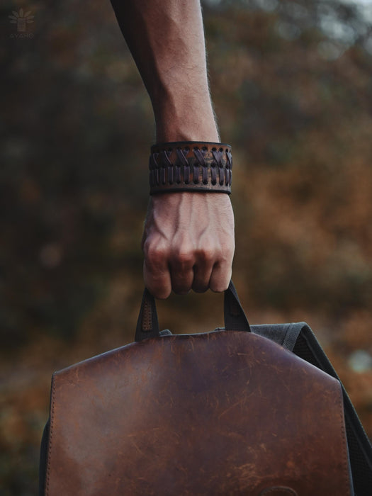 Rust-brown buffalo leather bracelet with triple-infinity loop design — a tribute to ancestral craftsmanship and natural power.