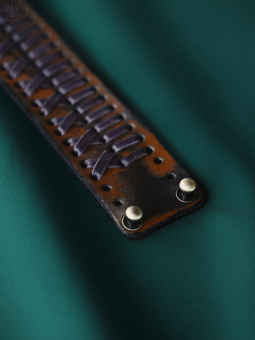 Buffalo leather bracelet with earthy rust-brown tones and a triple-infinity loop, a symbol of the continuous flow of body, spirit, and nature.