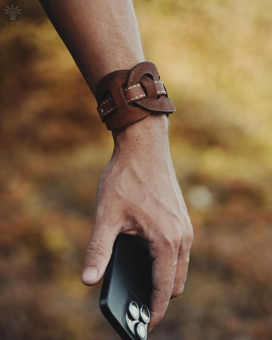 Bold and substantial buffalo leather cuff with triple-infinity design, representing timeless energy and cyclical power.