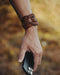Bold and substantial buffalo leather cuff with triple-infinity design, representing timeless energy and cyclical power.