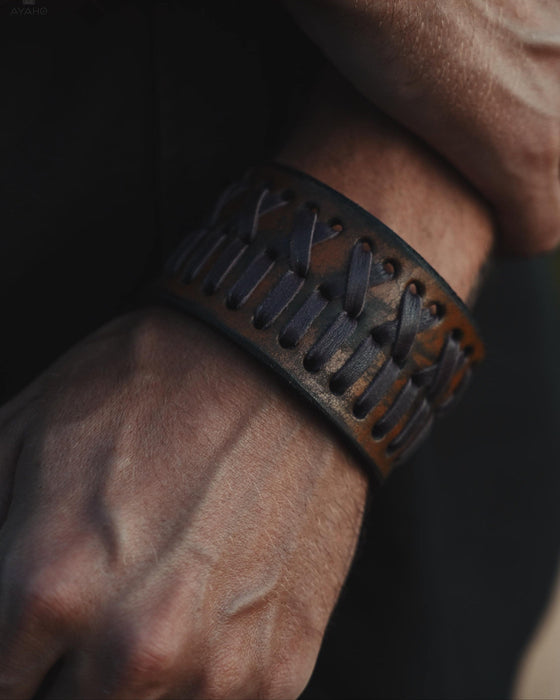 Handcrafted rust-brown buffalo leather bracelet featuring a triple-infinity design, symbolizing the flow of energy and balance.